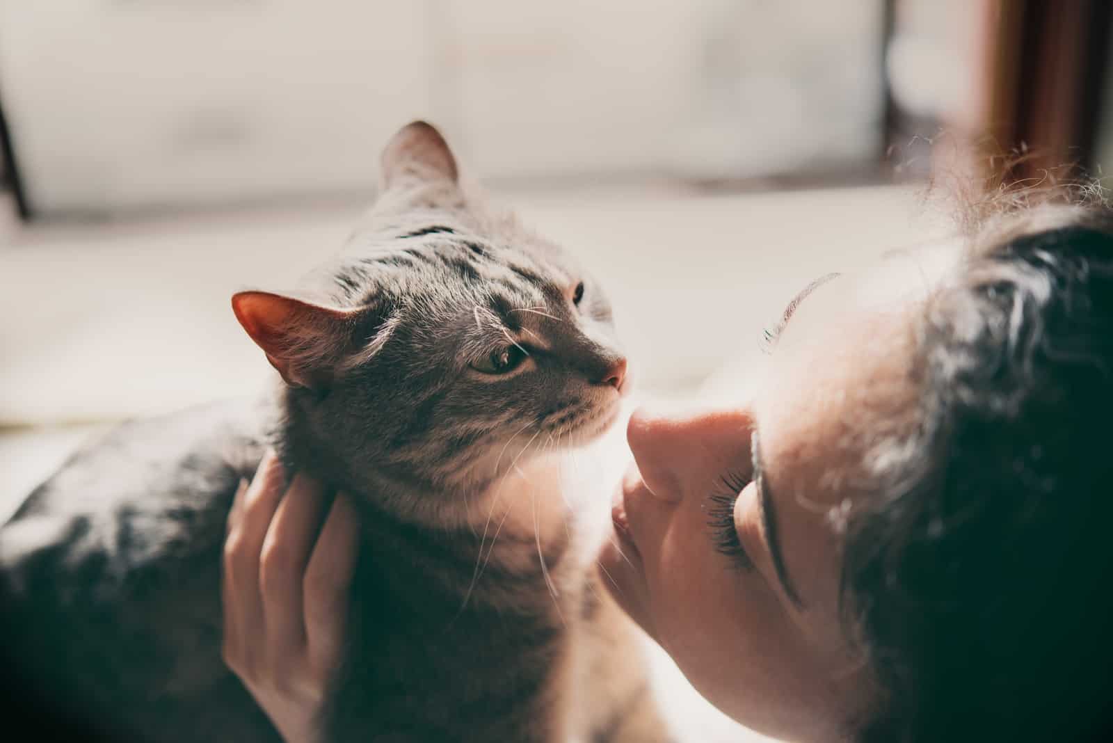 a woman holding a cat in her arms