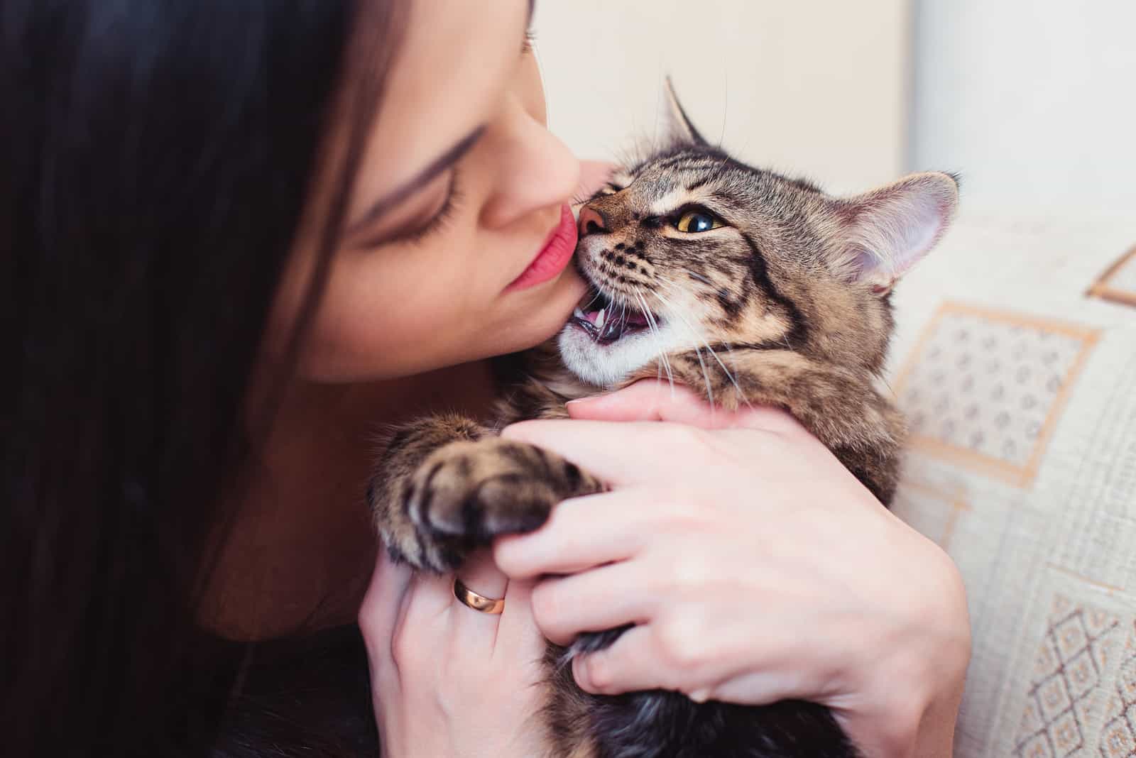 an angry woman holding a cat in her arms