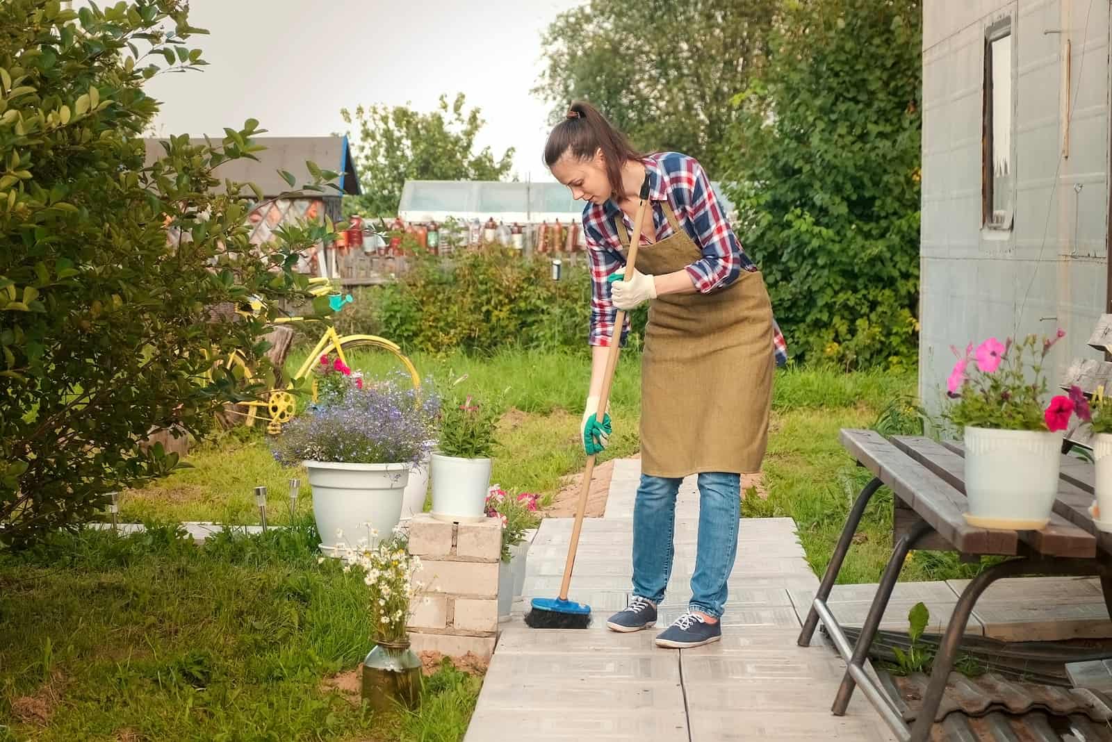 the woman cleans the yard