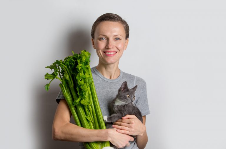 woman holding Celery and cat