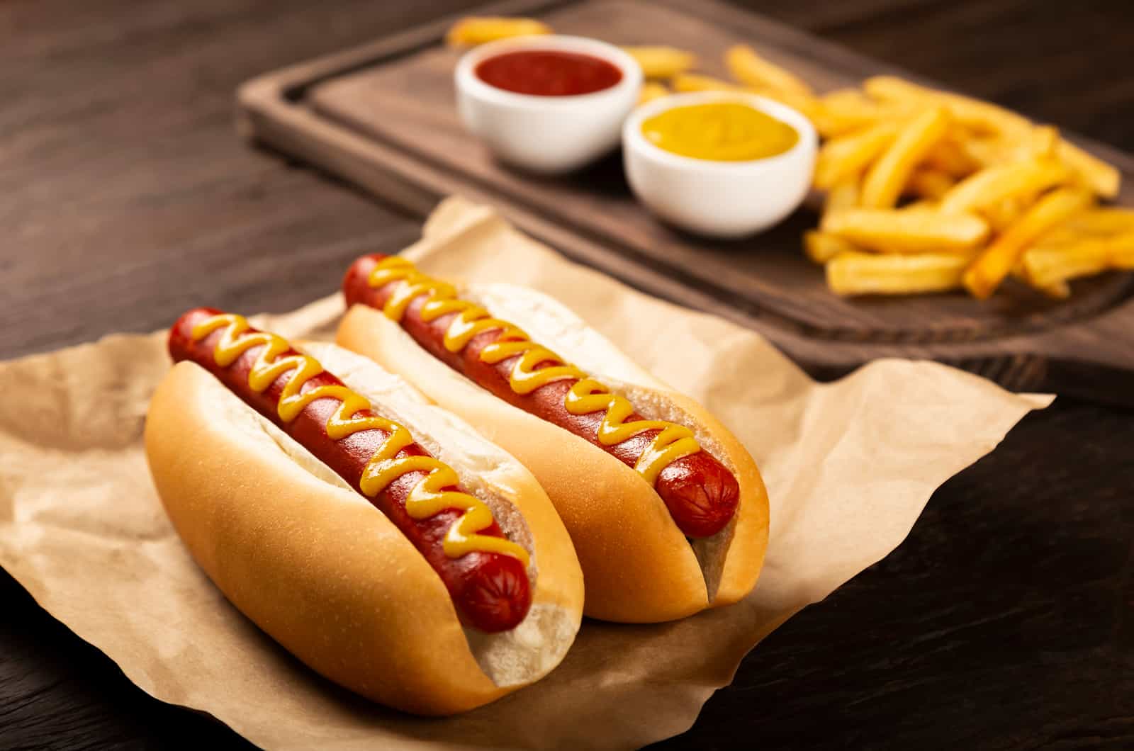 Hot dogs with ketchup, yellow mustard and fries