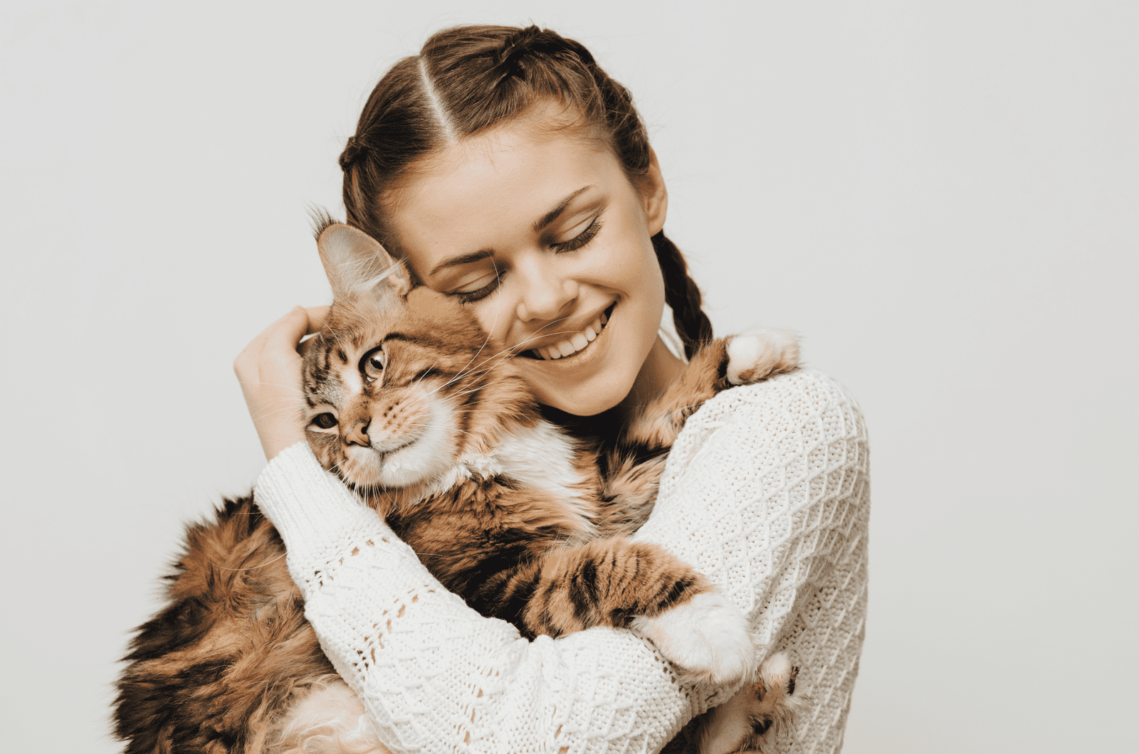 woman hugging maine coon cat