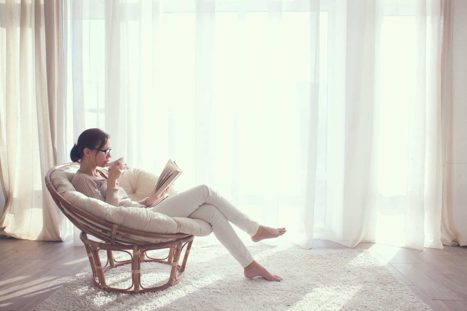 young woman drinking coffee and reading