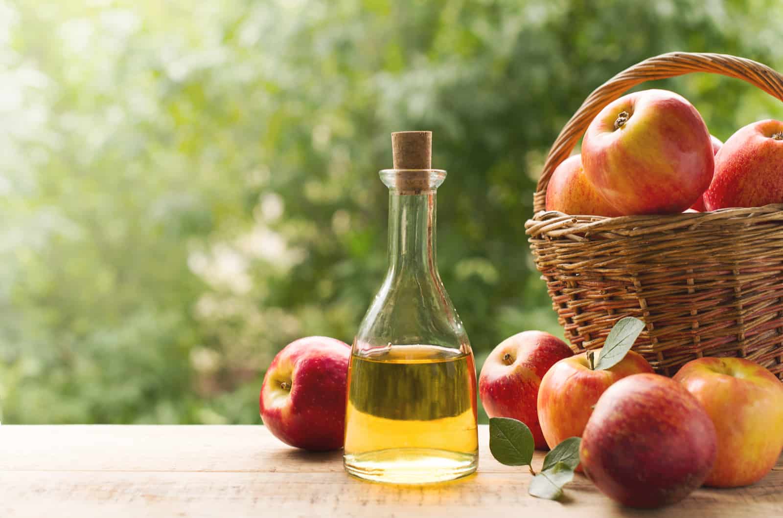 Apple cider vinegar in bottle with apples