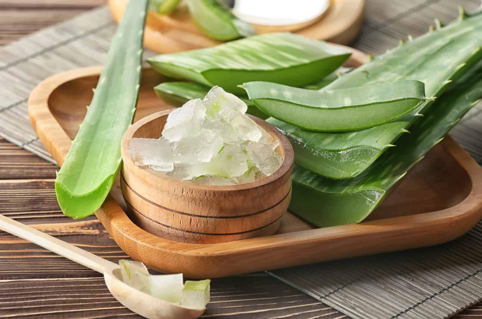 Bowl with aloe vera on wooden tray