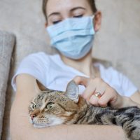 a sick woman with a cat in her lap