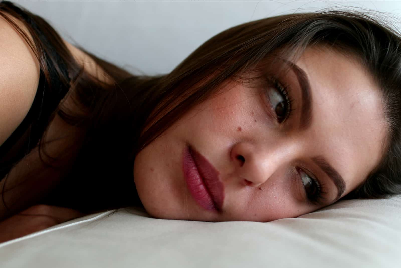 pensive woman lying on the couch