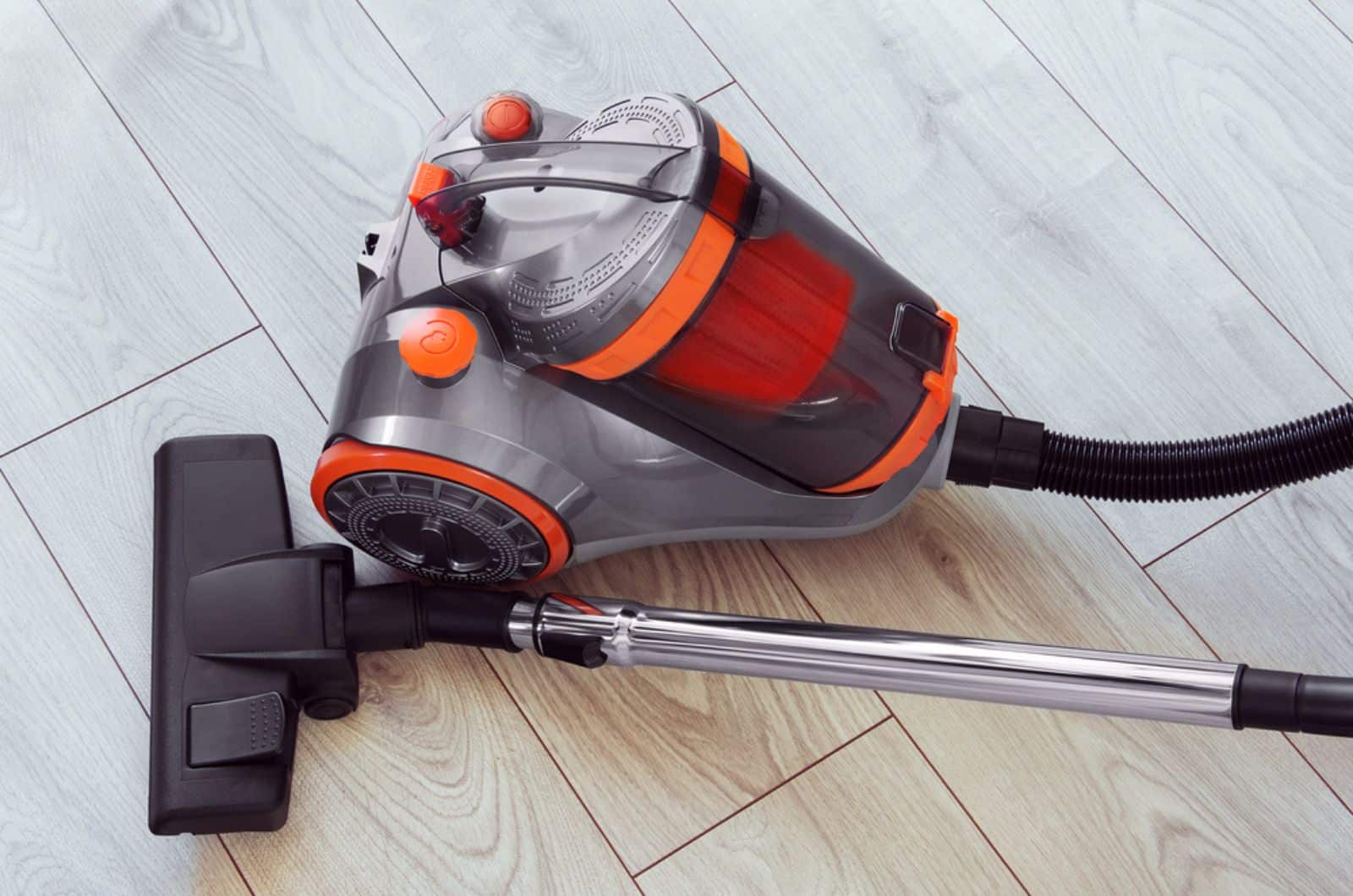 vacuum cleaner with orange color on gray laminate