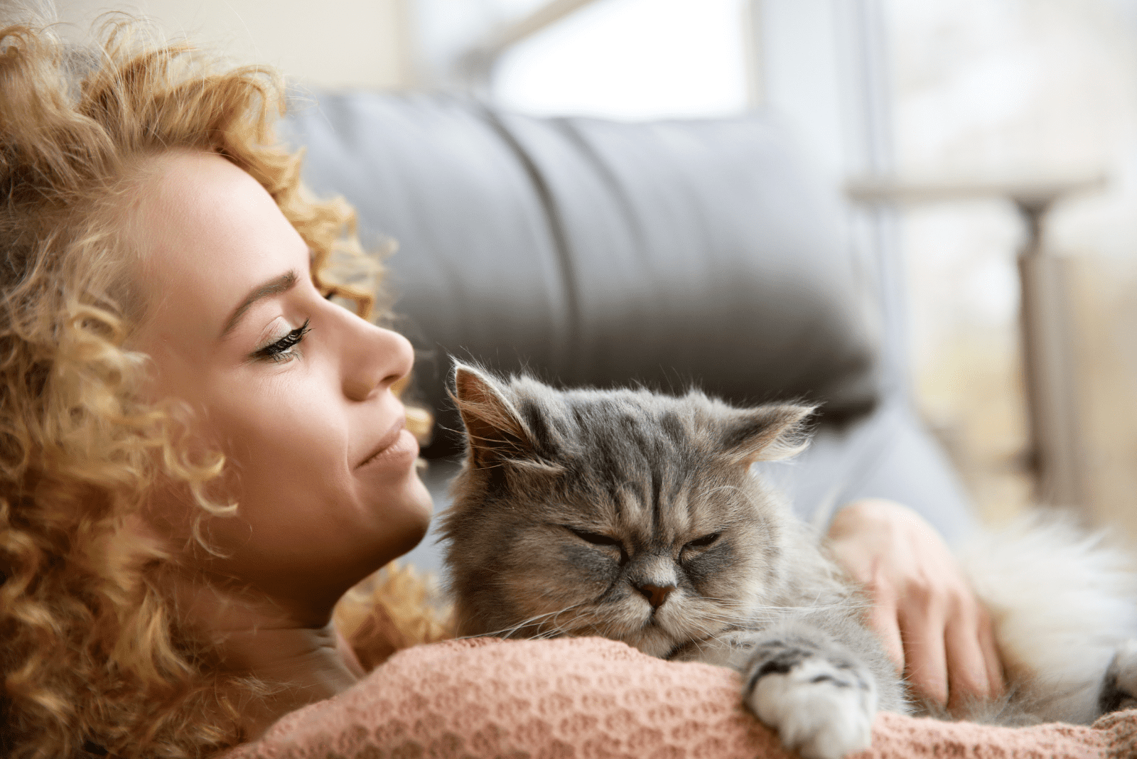 a beautiful woman in her arms with a cat
