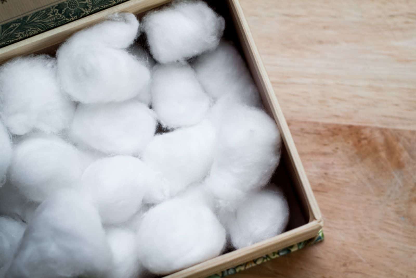  cardboard box full of white cotton balls