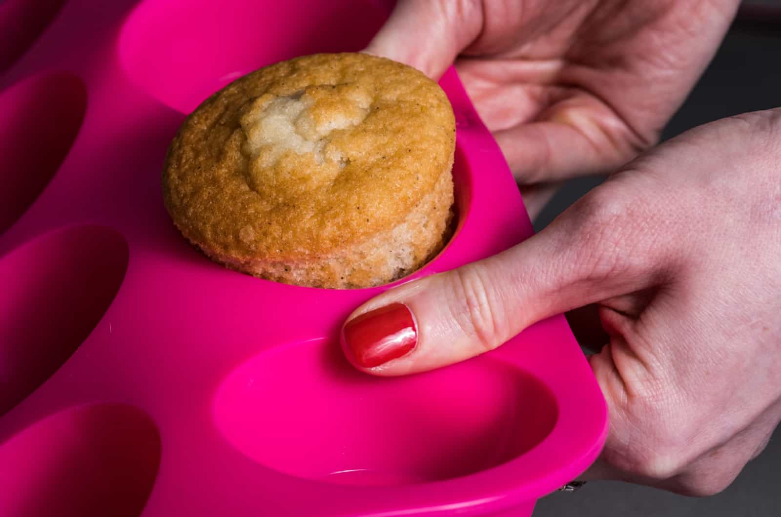 person taking out a muffin