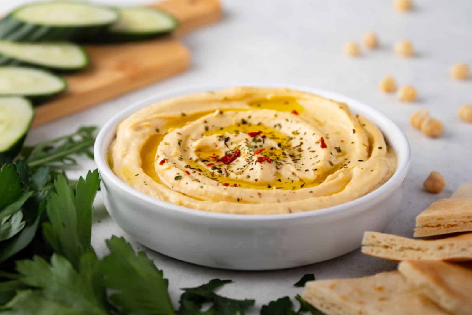 Hummus plate with cucumber slices and parsley