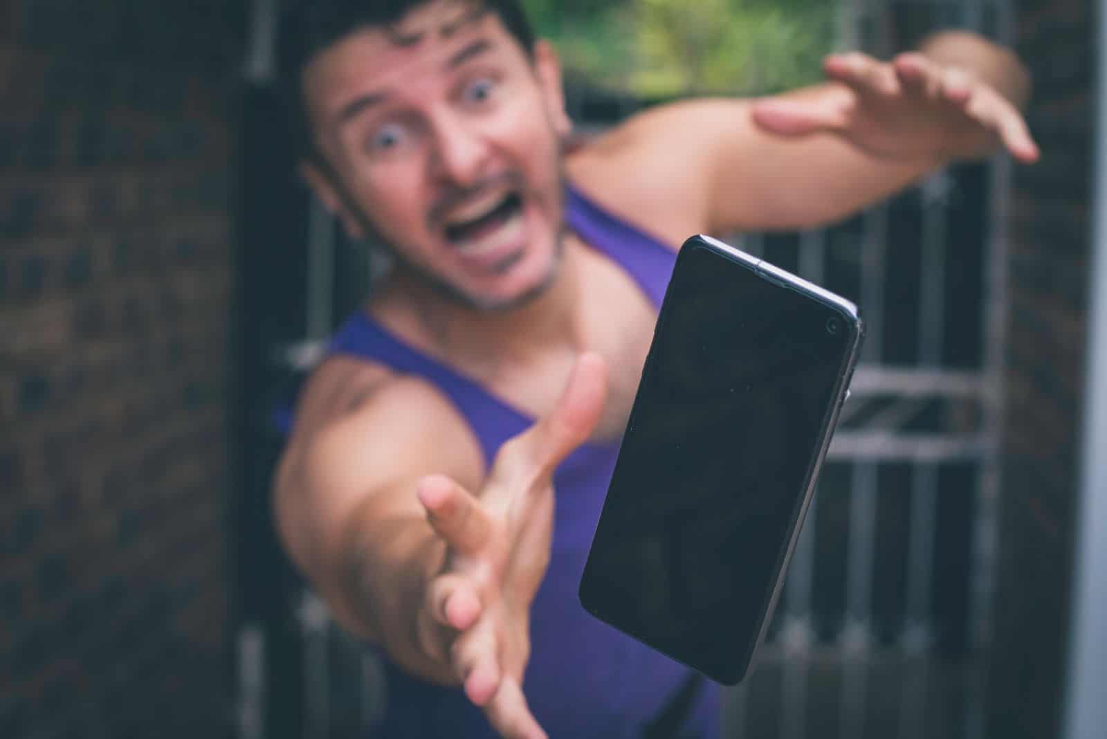 a man runs after a falling phone