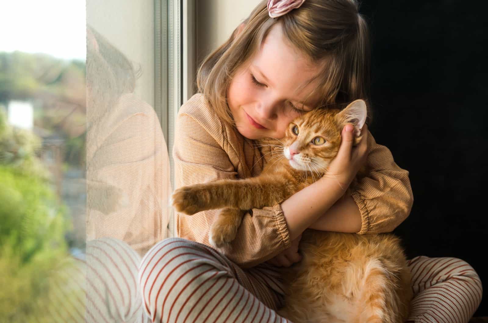 girl hugs cat