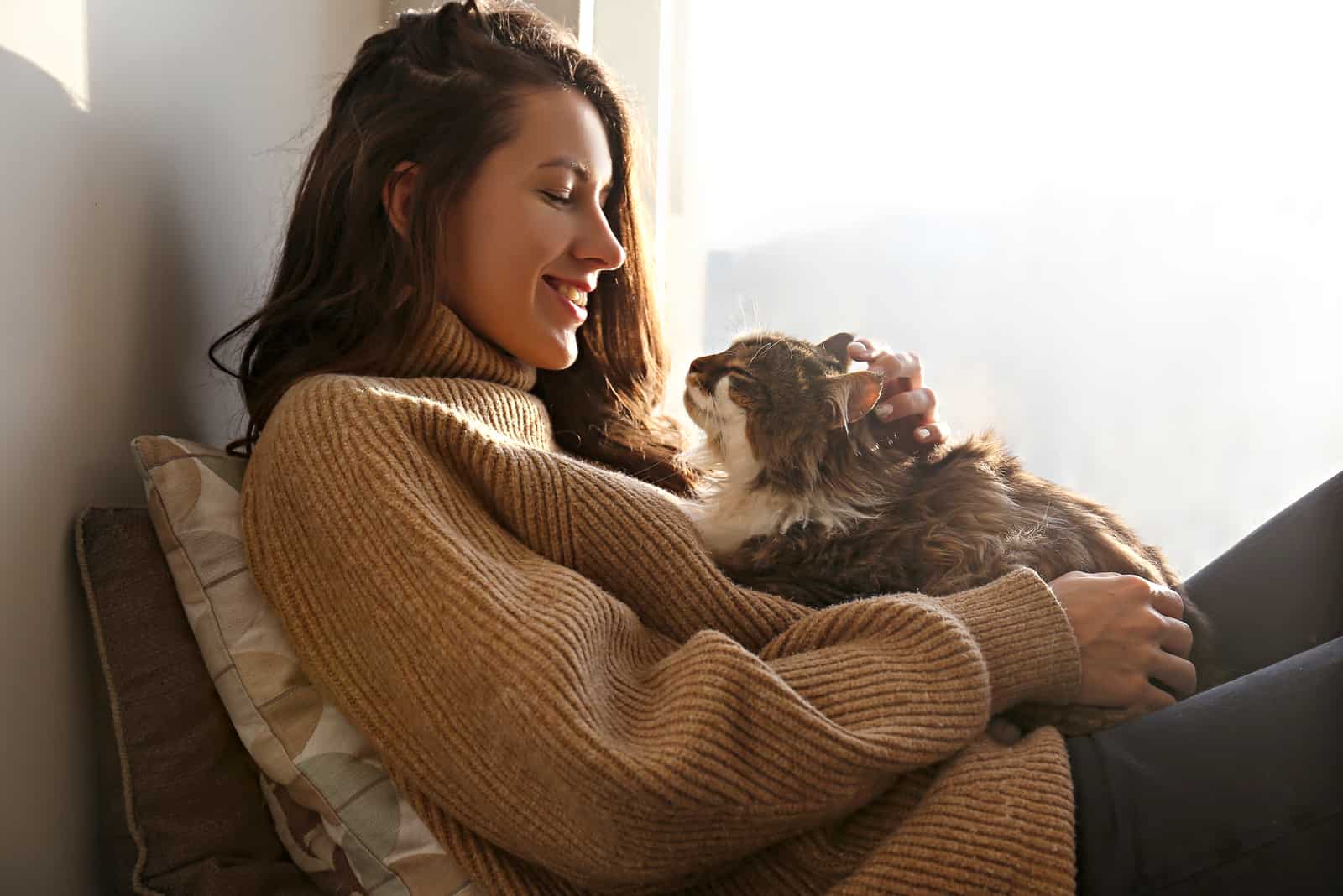 woman cuddling with her cat