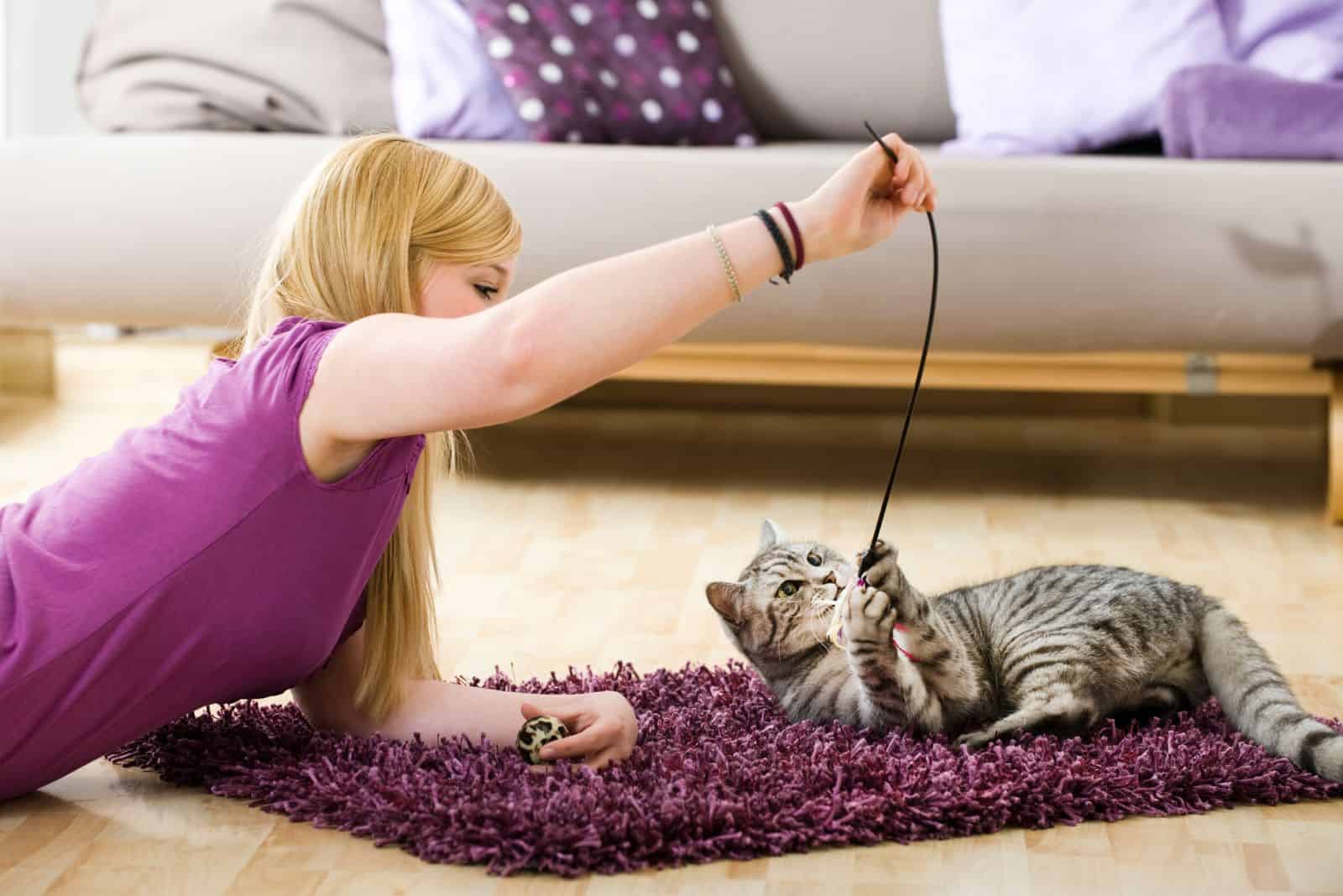 Girl playing with her cat