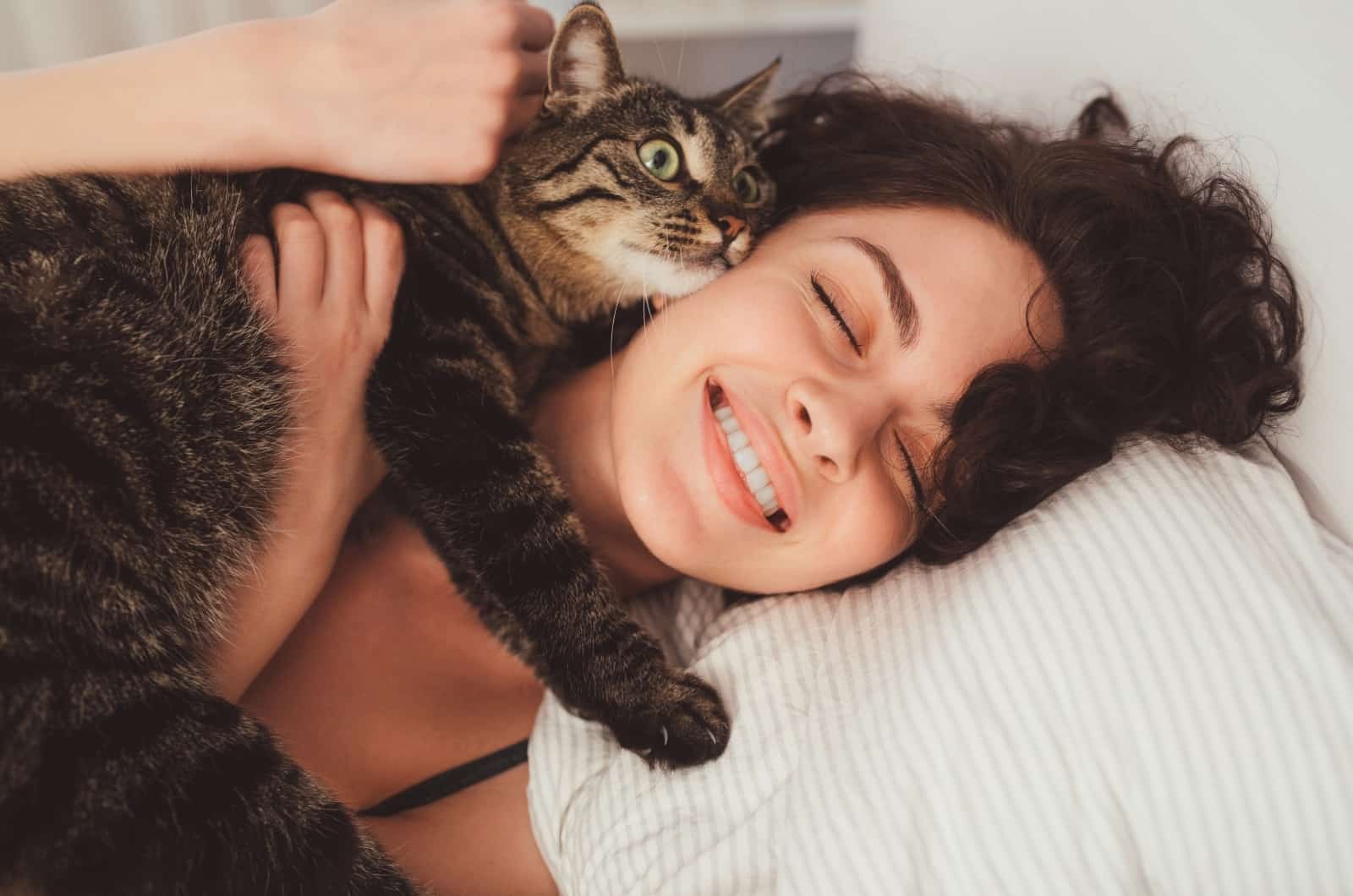 happy woman cuddling with her cat