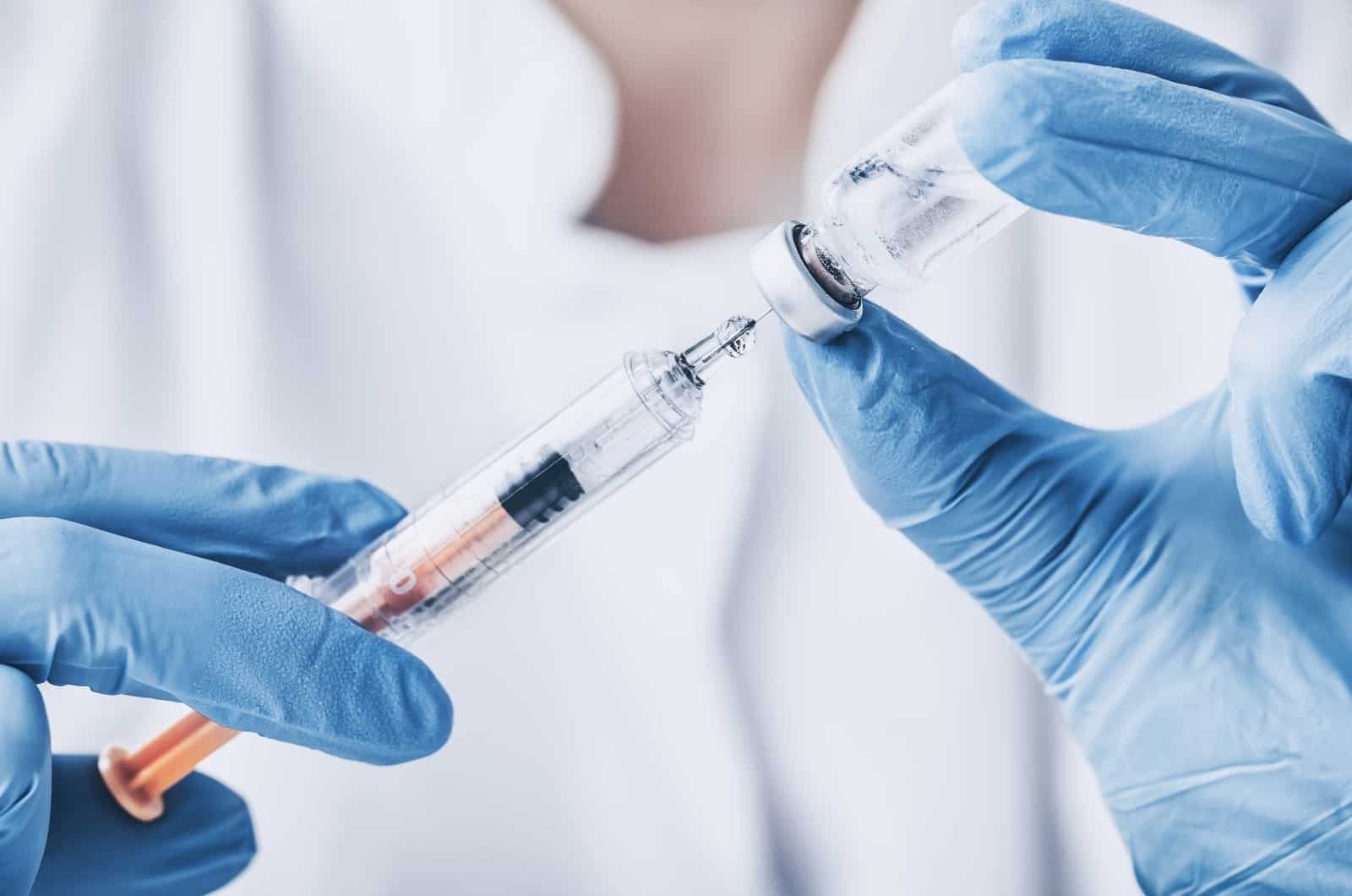 putting injectable antibiotic into needle