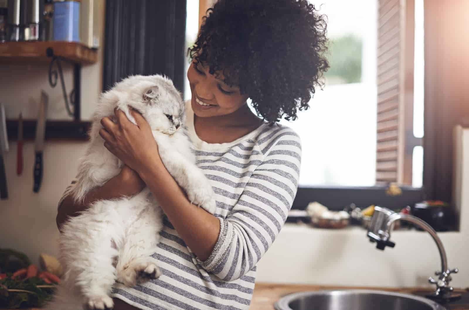 woman petting her white cat