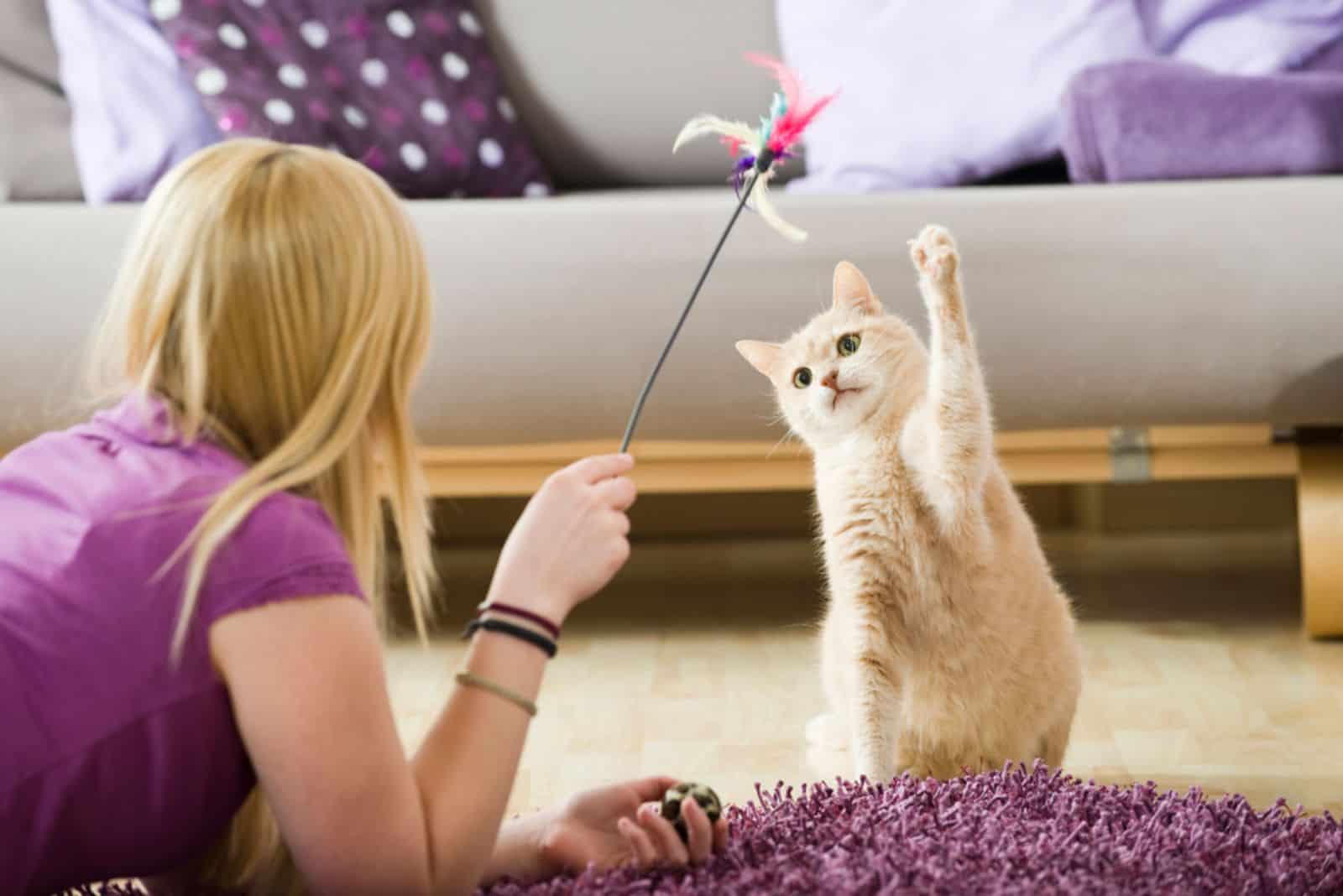 Girl playing with her cat