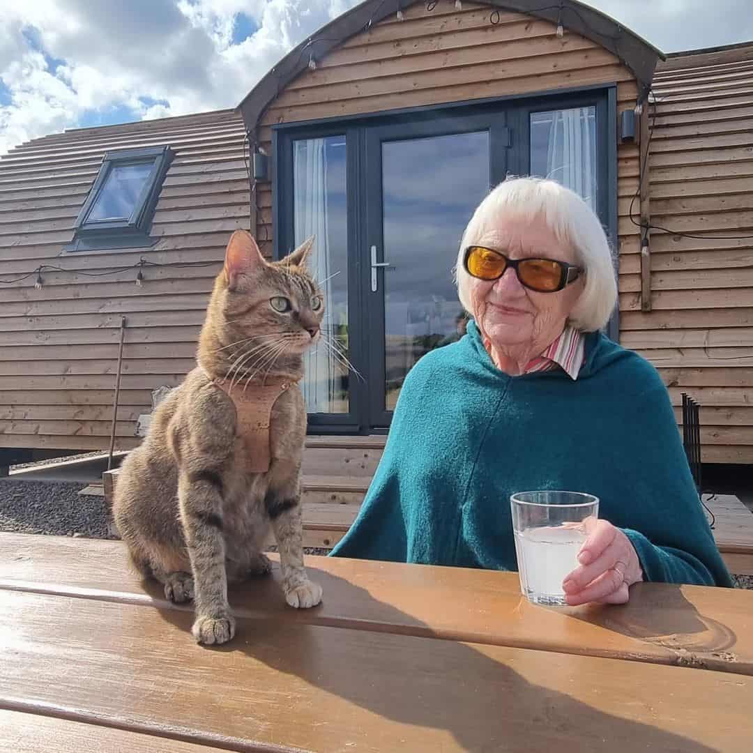 Nala photographed next to a senior woman during a camping trip