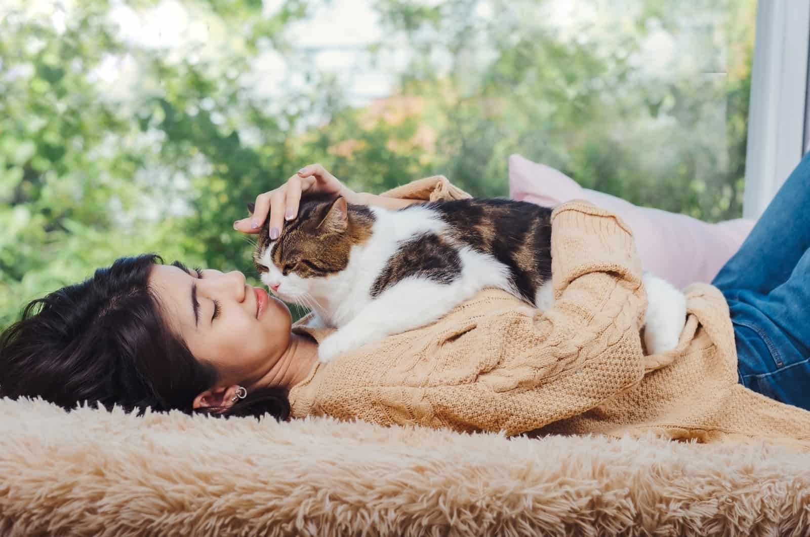 cat lying on young girl chest