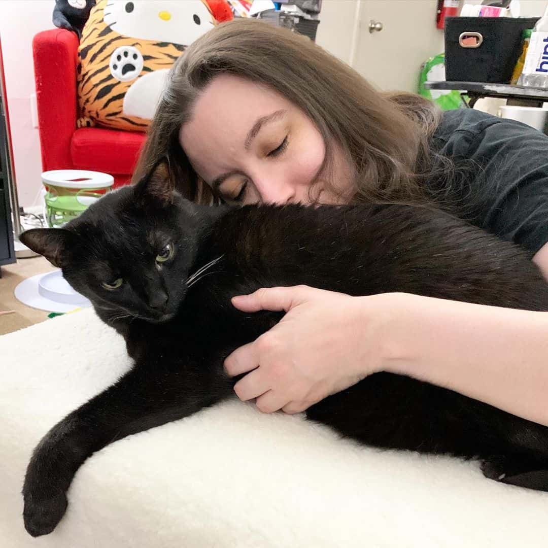 woman hugging her cat