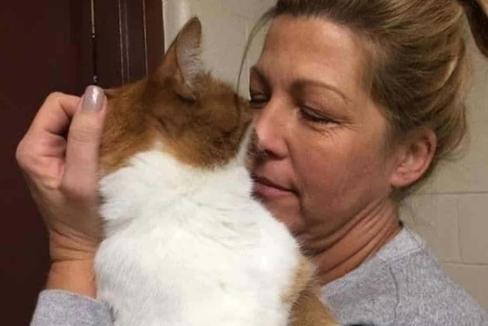 a woman petting a cat