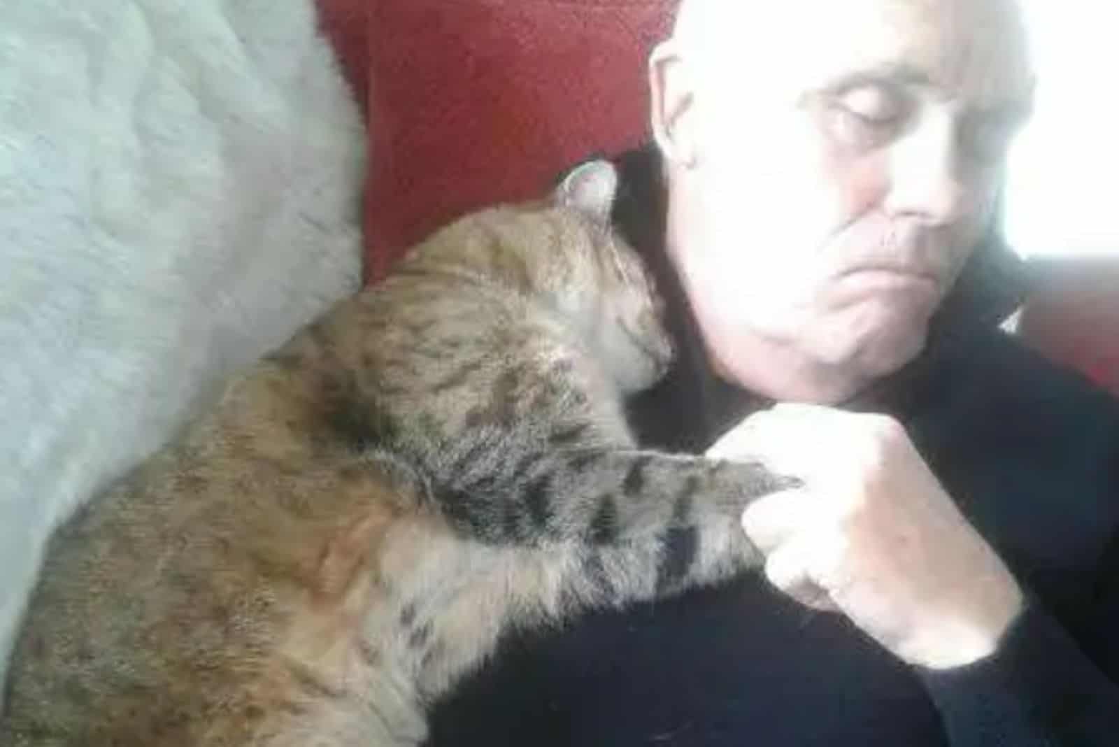 Dad recovers from surgery with a random cat snuggled in his lap
