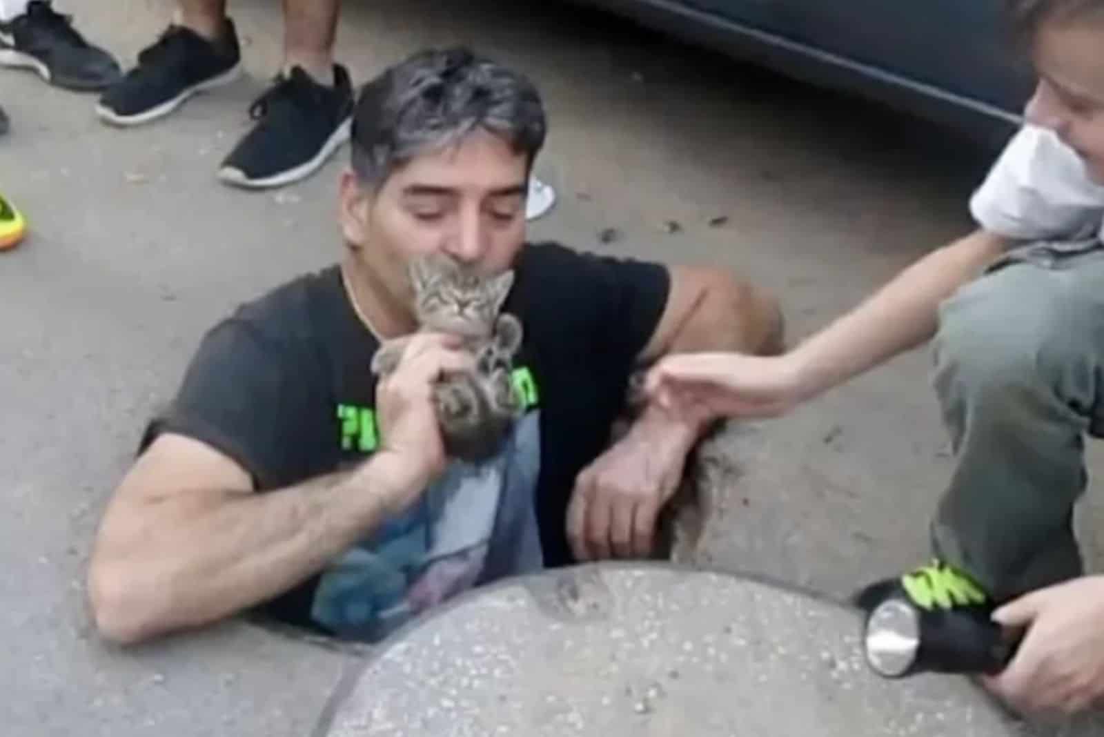 happy man kisses the rescued kitten