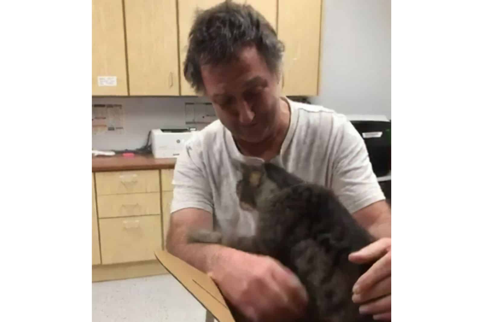 man crying from happines with cat