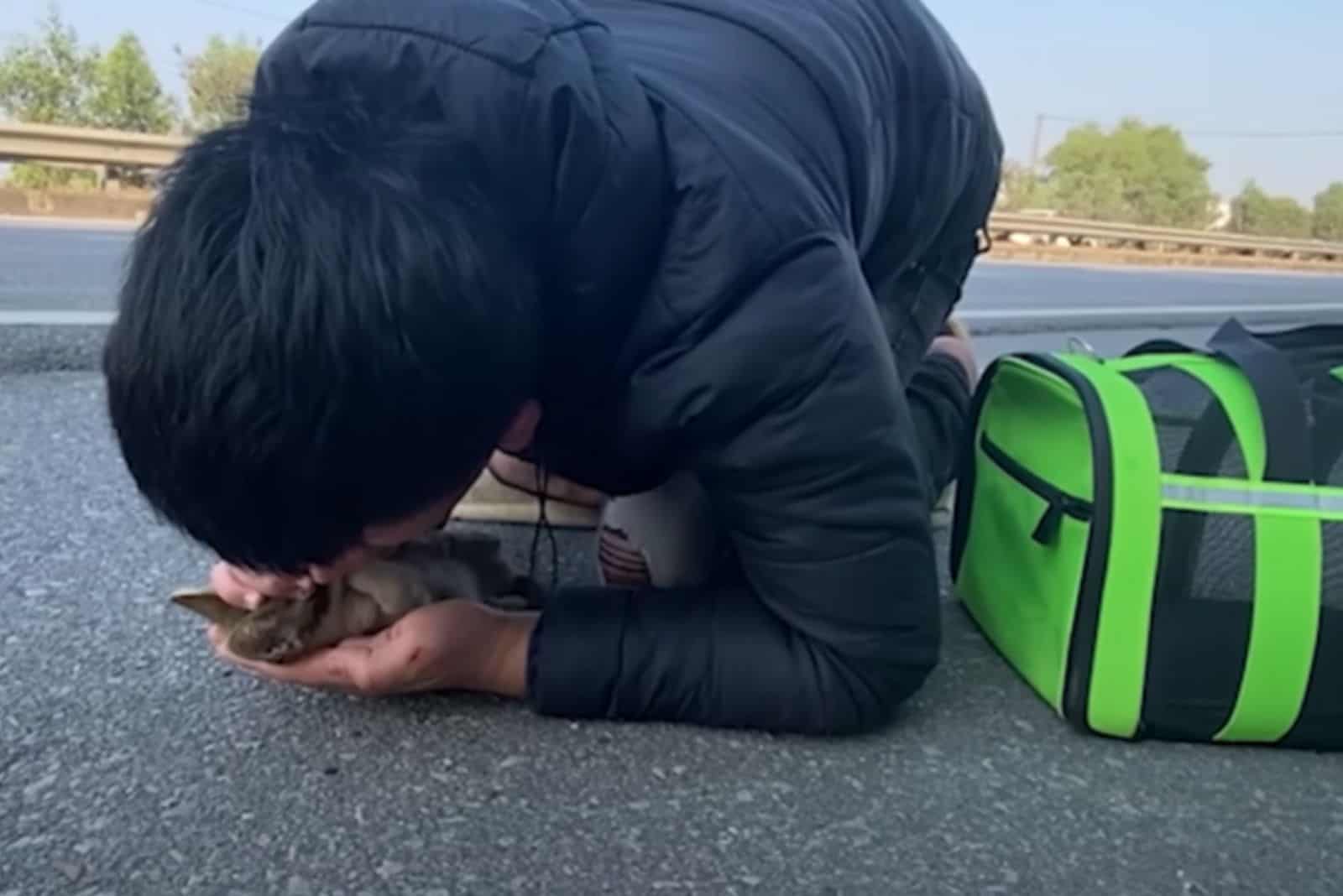 rescuer tries to save a little kitten