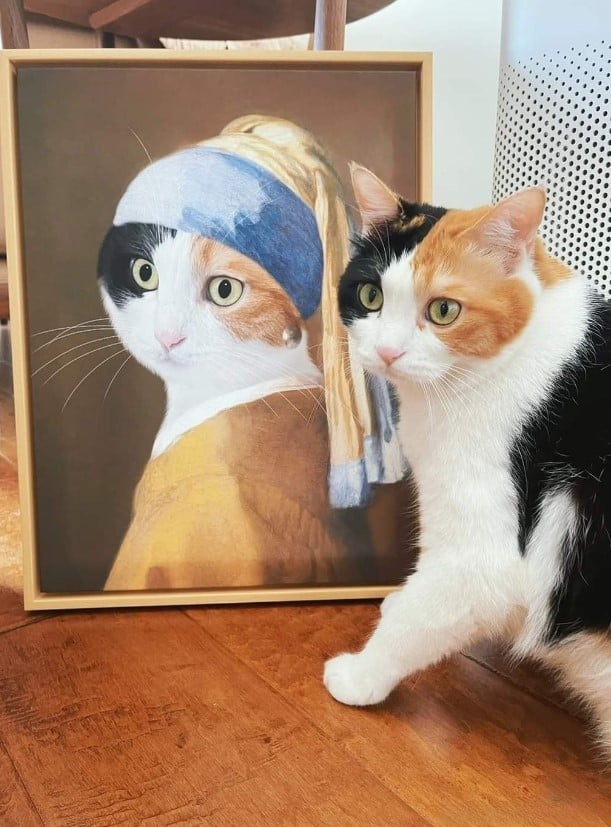 the cat is standing in front of his portrait