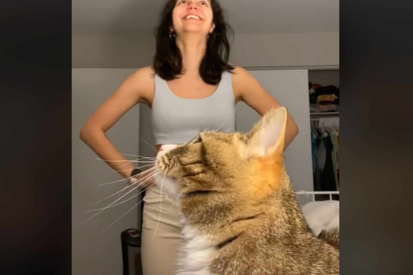 the cat looks at the woman in the video