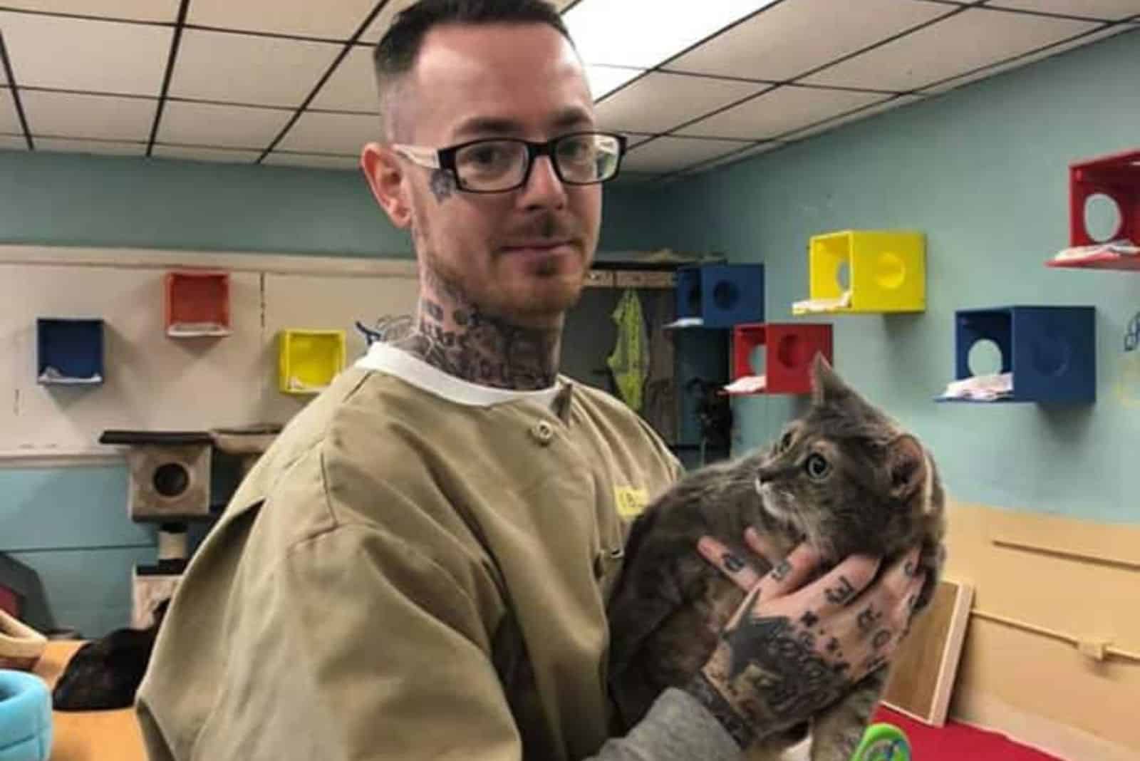 Full tatooed guy holding a cat