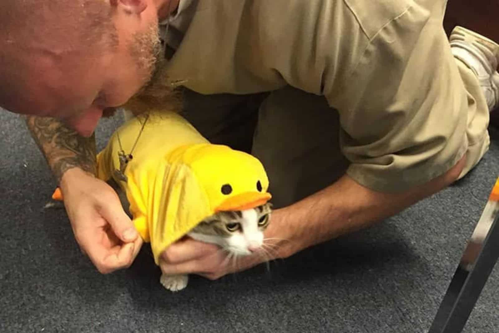Man and cat with duck costume