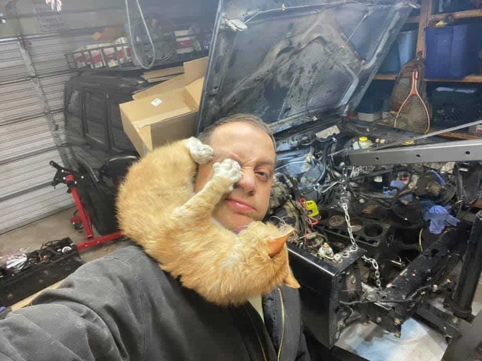 man with cat in the garage