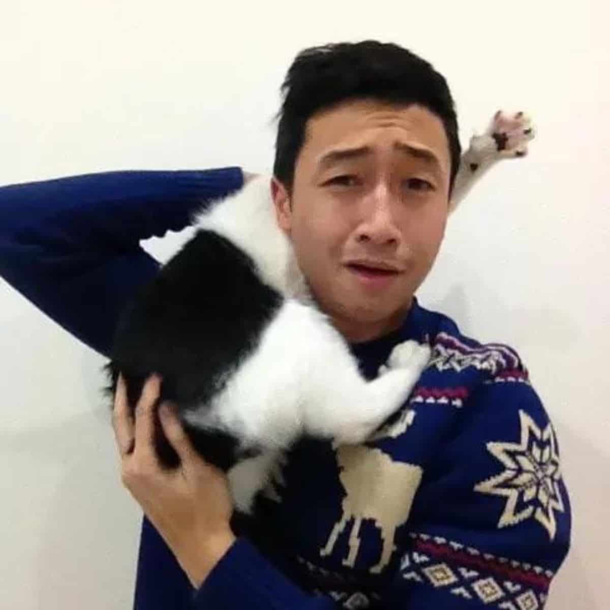 a cat on a man's shoulder