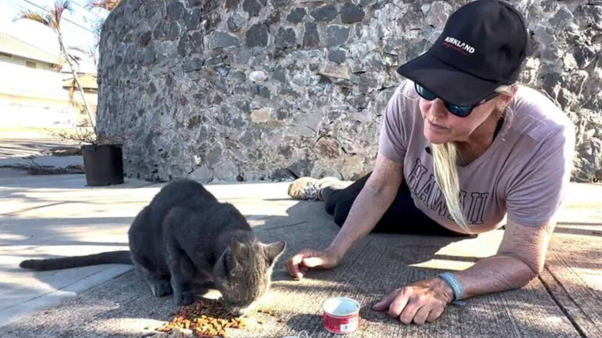 woman feeding cat