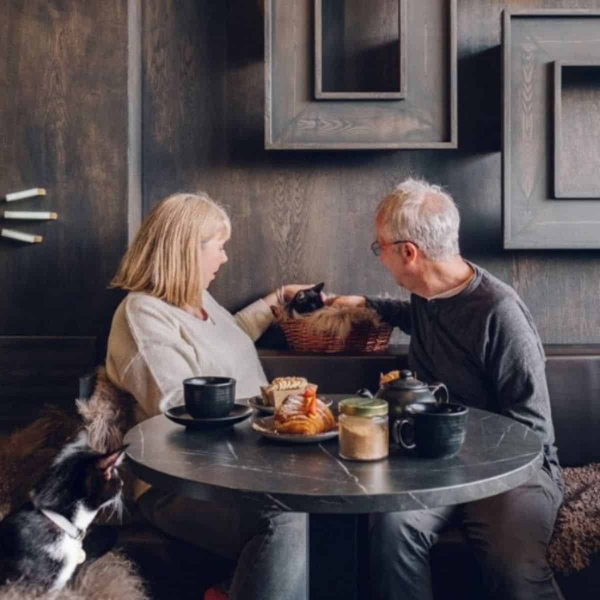 senior couple in a cafe with cat