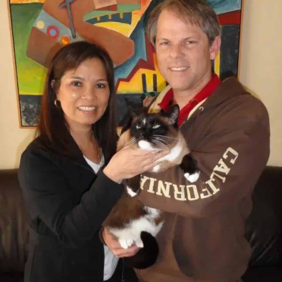 couple holding a cat