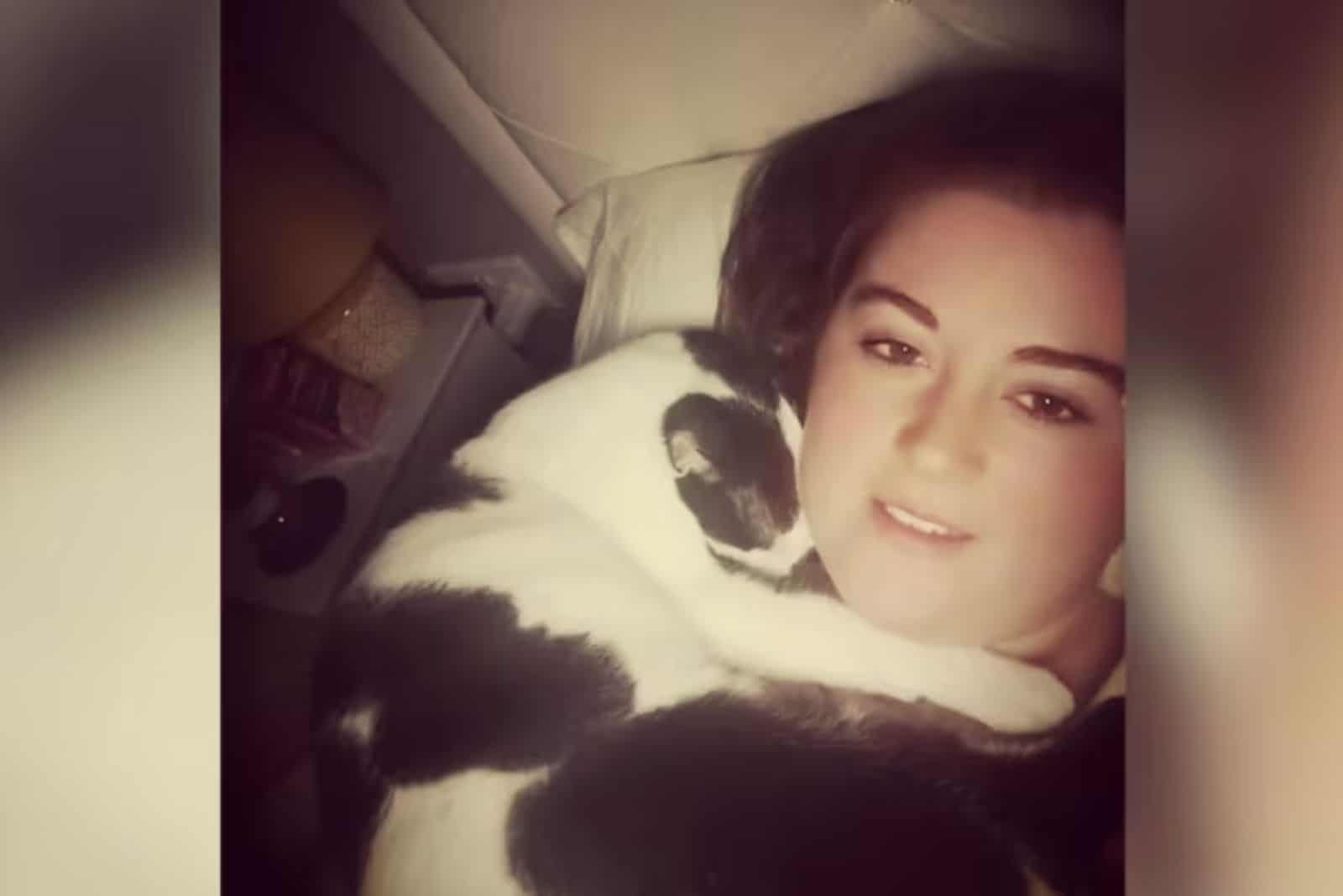 girl laying with her cat