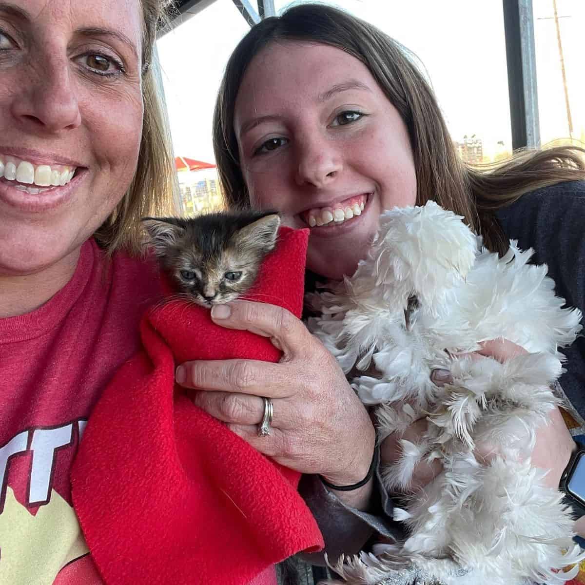 photo of two women and kitten