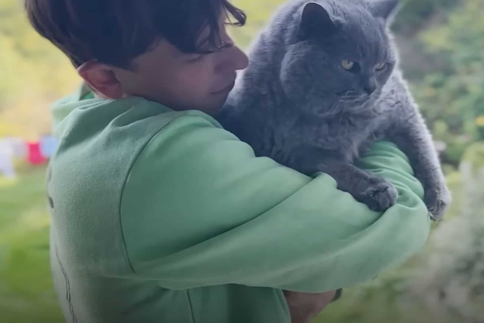 man holding cat in his arms