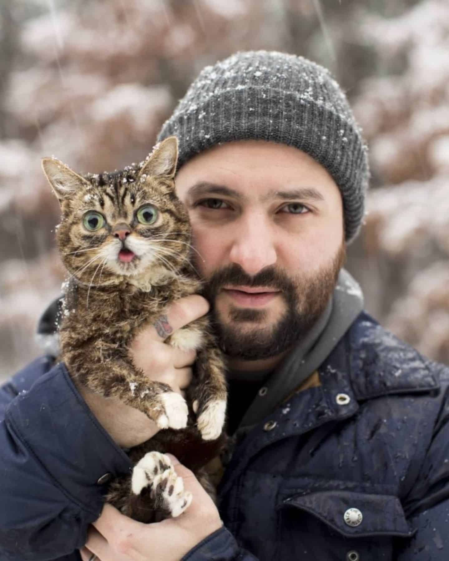 portrait of a man holding a cat in his hands