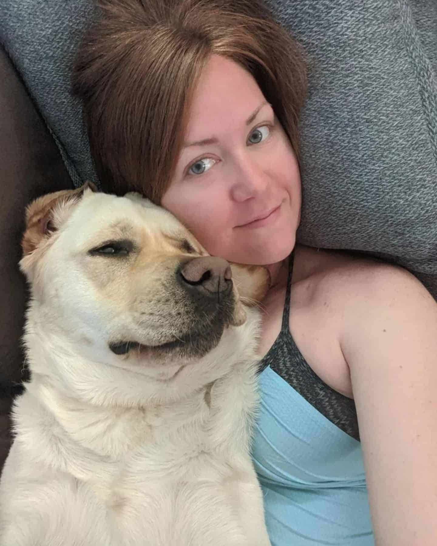 woman posing with dog on the couch