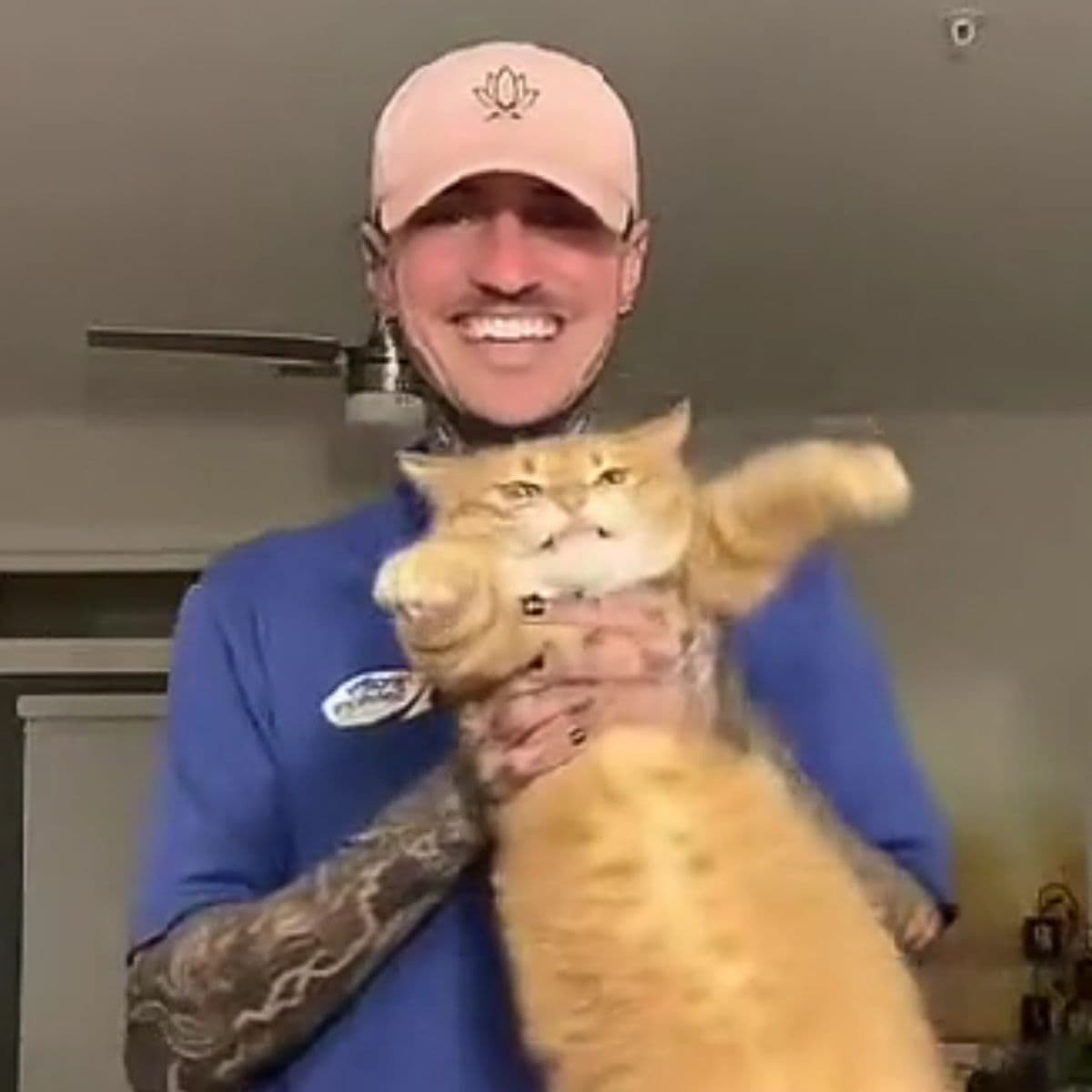 man holding ginger cat