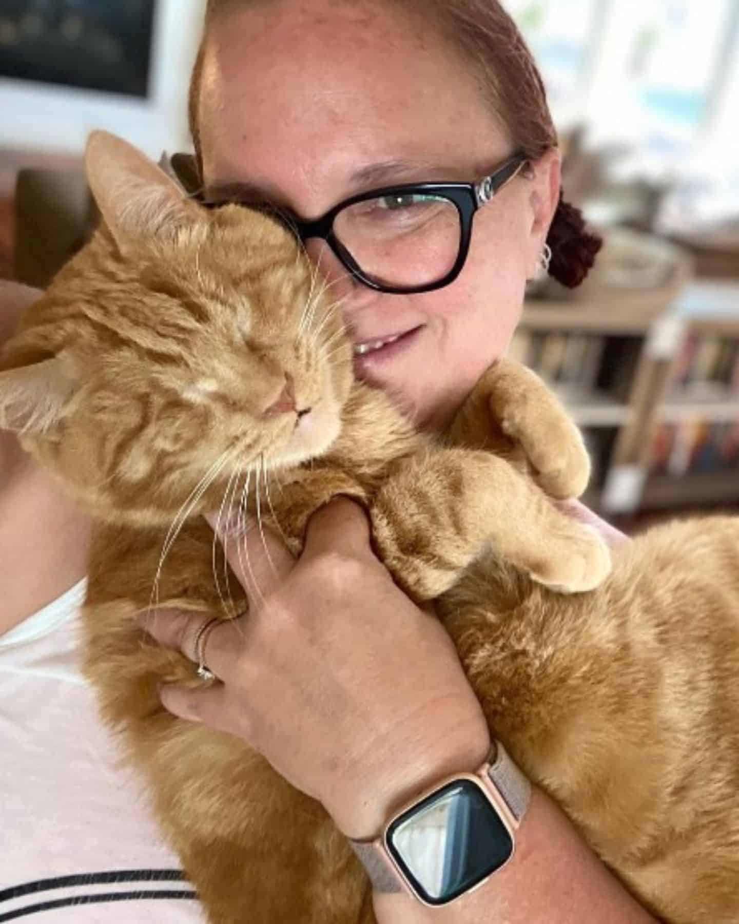 woman hugging blind cat