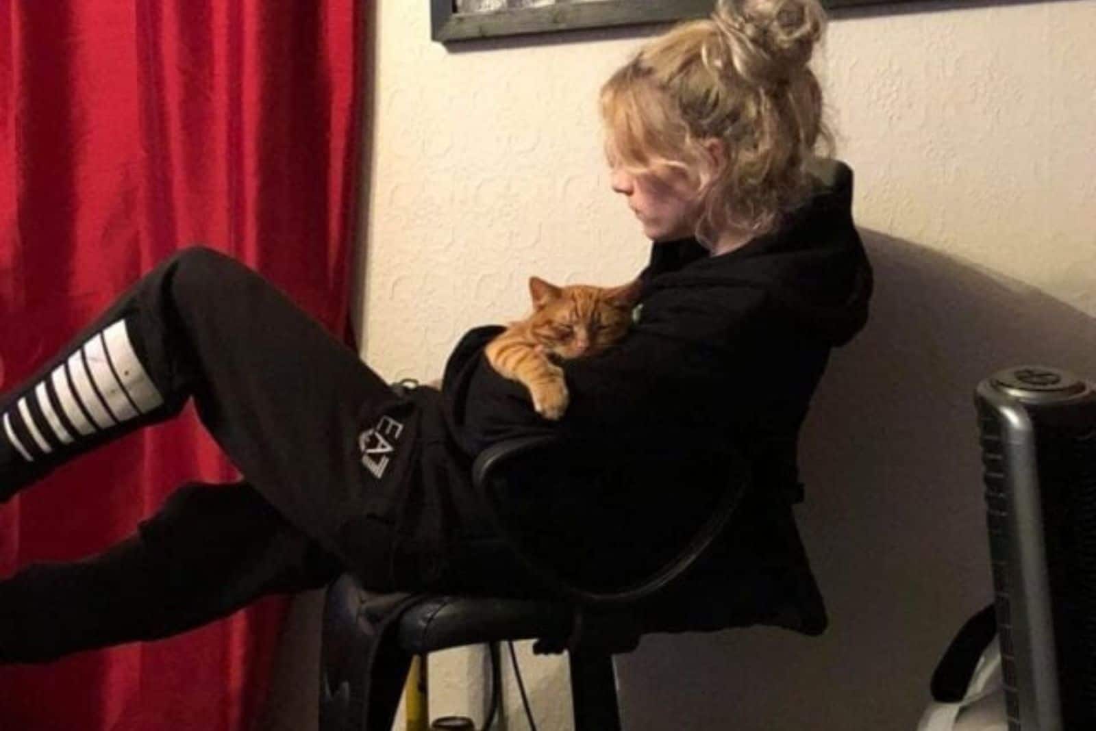 blonde woman holding her cat