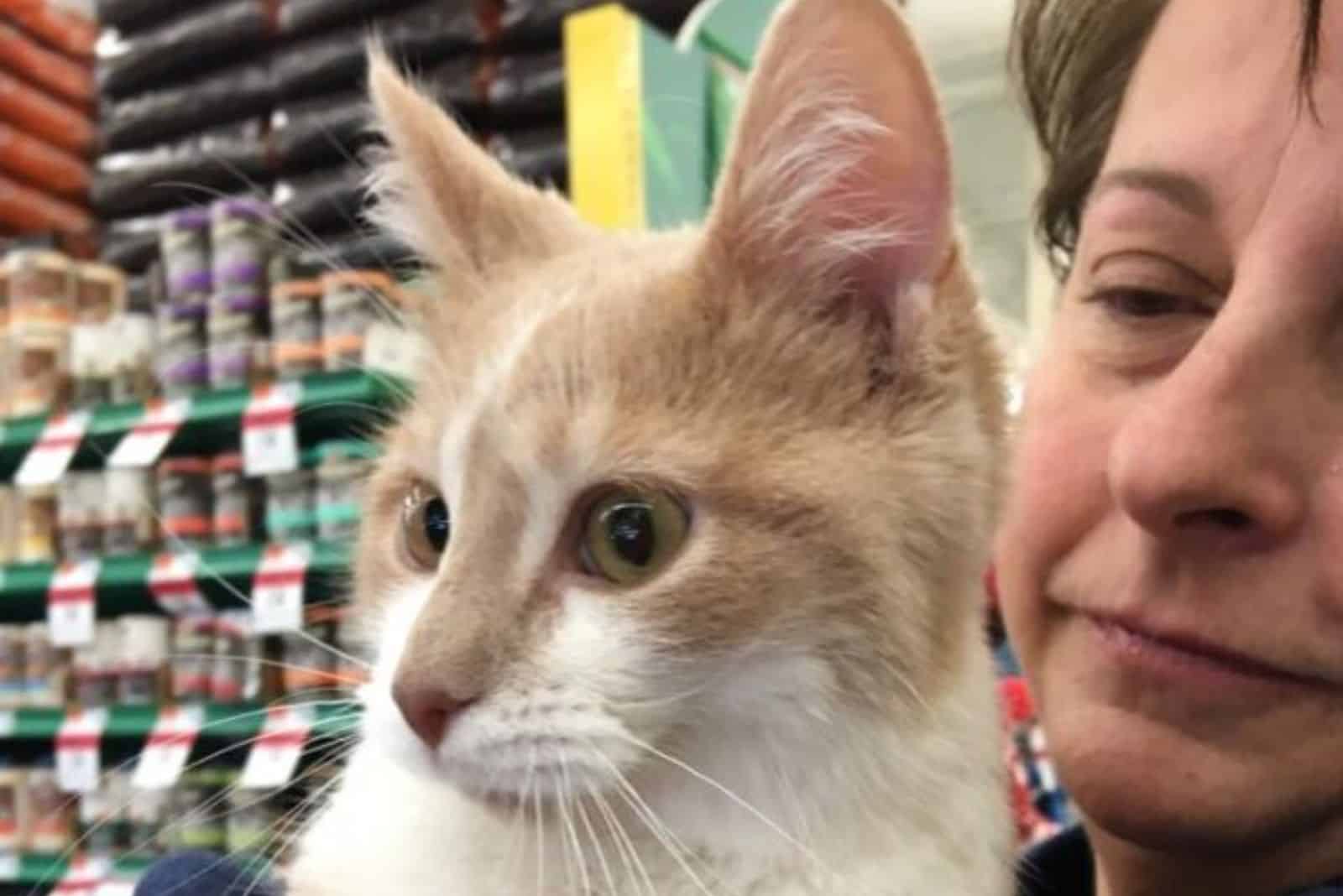 cat and owner in a store